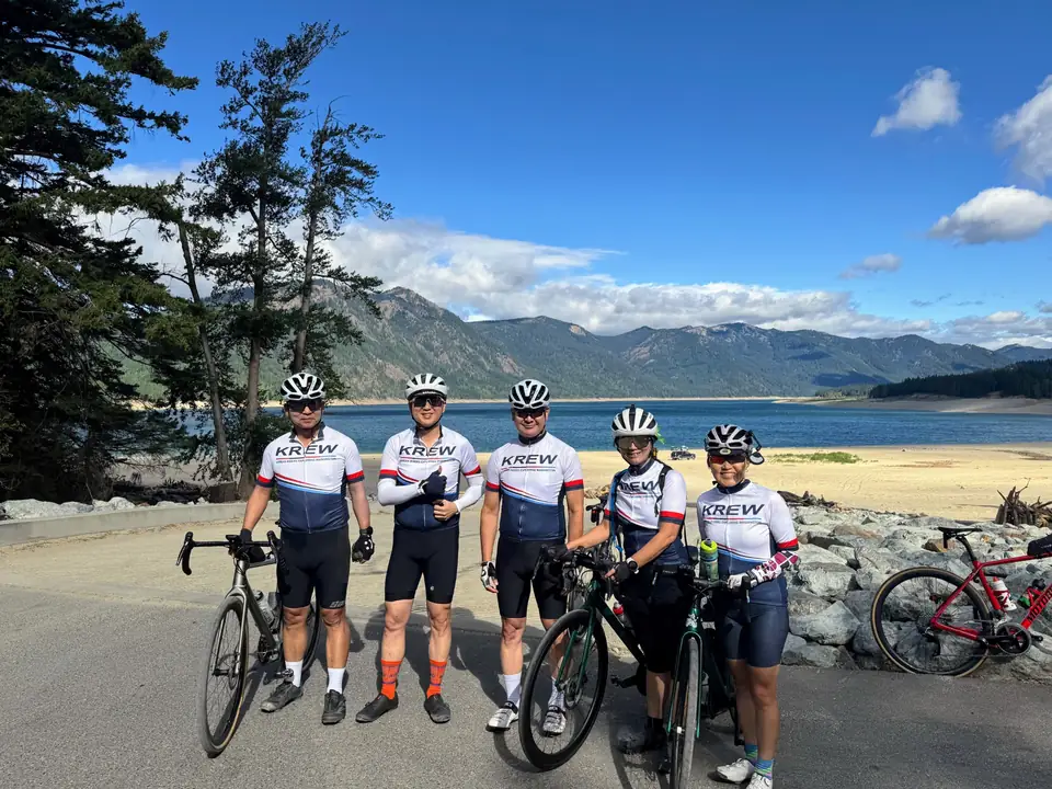 KREW cyclists together by a mountain lake in Washington